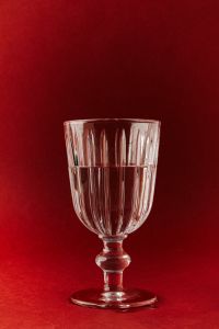 Kaboompics - Ribbed Crystal Goblet on Red Background