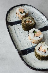Kaboompics - Sesame and Nori Sushi Rolls on a Handcrafted Ceramic Platter