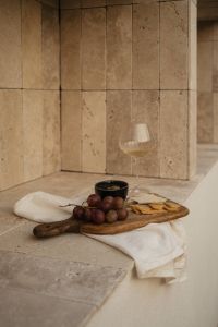 Kaboompics - Grapes, Cheese Board and Wine Glass on Travertine Ledge