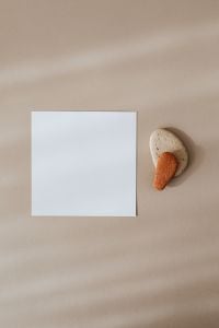Kaboompics - Blank Card Mockup with Textured Natural Stones on Beige