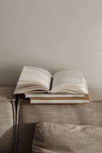 Kaboompics - Open Planner on Stacked Notebooks Along a Neutral Sofa, Home Office Copy Space
