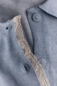 Kaboompics - Vertical Detail of Blue Knit Fabric With Buttons