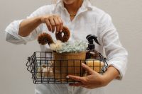 Kaboompics - Woman Carrying a Wire Basket with Cleaning and Home Care Items