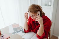 Kaboompics - Woman Talking on Smartphone beside Laptop at Home Office Desk