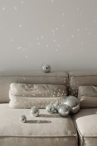 Kaboompics - New Year's Eve Party Background with Disco Balls and Reflected Light on a Gray Sofa