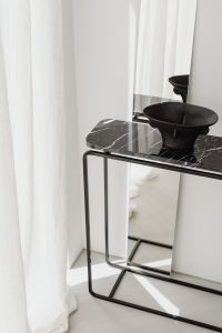 Kaboompics - Black Bowl On Marble Console Near Sheer Curtains