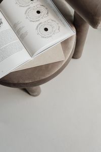 Kaboompics - Open Book with Circular Diagrams on Beige Upholstered Chair