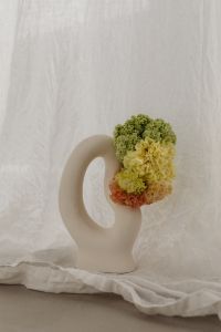 Kaboompics - White Sculptural Vase with Green and Peach Flowers
