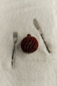 Kaboompics - Red Christmas Ornament with Silver Cutlery in Snow
