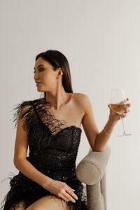 Kaboompics - Seated Woman Looking to the Side while Holding a Wine Glass in an Armchair