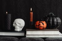 Kaboompics - Skull Candle and Pumpkins on Stacked Books