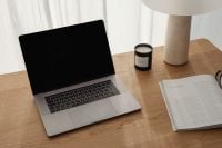 Kaboompics - Work From Home Desk with Laptop, Candle and Open Magazine