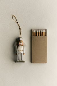 Kaboompics - Nutcracker Ornament and Matchbox on White Background