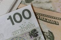 Kaboompics - Close-Up of a 100 Polish Zloty Note Overlapping US Dollar Cash