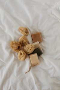 Kaboompics - Natural Sea Sponges and Handmade Soap Bars on White Linen