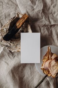 Kaboompics - Vertical Business Card Mockup beside Textured Stone and Dried Rose