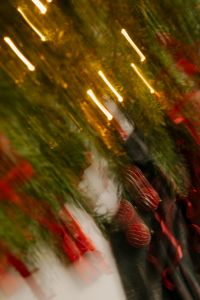 Kaboompics - Diagonal Golden Light Trails on Christmas Tree with Red Ribbons and Gifts