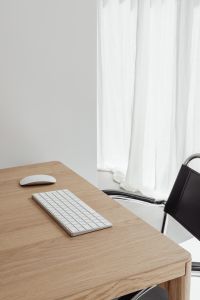Kaboompics - Bright Home Office Desk with Keyboard and Sheer Curtain Background
