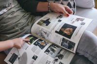 Kaboompics - Woman reading a designer magazine on a couch