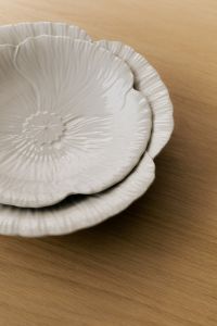 Kaboompics - Stacked White Ceramic Plates on Wood, Scalloped Floral Tableware Detail