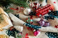 Kaboompics - Christmas gift and colourful tree decorations on a blanket