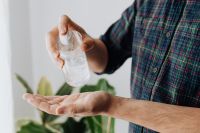 Kaboompics - Person Applying Clear Hand Sanitizer Gel Near Greenery