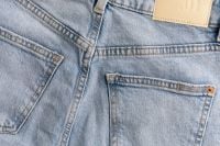 Kaboompics - Wide Back View of Light Wash Jeans with Two Pockets, Copper Rivet and Tan 01 Patch