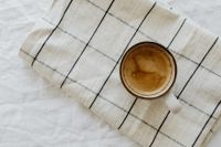 Kaboompics - Coffee Cup on a White Checkered Blanket