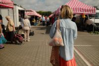 Kaboompics - Woman Walking Through a Farmers Market