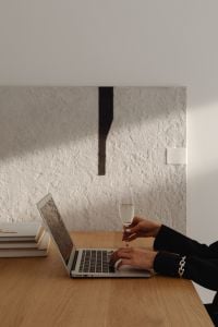 Kaboompics - Laptop and Wine Glass on a Wooden Desk