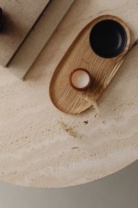 Kaboompics - Black Coffee Cup and Amber Candle on a Wooden Tray over Travertine Texture
