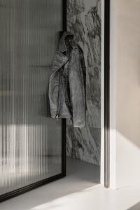 Kaboompics - Black Leather Jacket Hanging in Marble Hallway