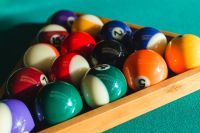 Kaboompics - Billiard balls on green table with billiard cue