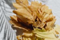 Kaboompics - Golden Oak Leaves on White Linen with Soft Shadows