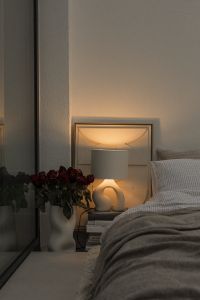 Kaboompics - Warm Lamp and Flowers Beside a Cozy Bed