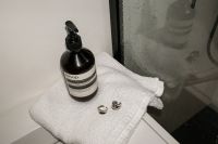 Kaboompics - Minimal Sink Ledge with Perfume and Red Beauty Product