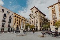 Kaboompics - Historic Madrid Plaza with a Central Monument and Outdoor Cafe Tables