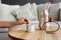 Kaboompics - Hand Lighting a Candle Beside a Sculptural Vase