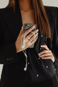 Kaboompics - Close-Up of Smartphone, Earphones and Black Suit