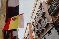 Kaboompics - Spanish Flag Beside Iron Balconies and Shuttered Windows on Madrid Facade