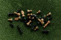 Kaboompics - Scattered Chess Pieces on Green Grass