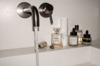 Kaboompics - Bathroom Sink Faucet and Luxury Perfume Bottles on White Ledge