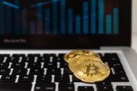 Kaboompics - Bitcoin Coin on Laptop Keyboard With Market Chart