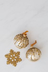 Kaboompics - Pair of Gold Beaded Ornaments and Glitter Snowflake, Christmas Flat Lay