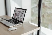 Kaboompics - Laptop and White Mouse on a Wooden Home Office Desk by a Bright Window