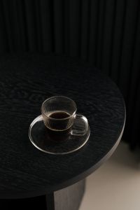 Kaboompics - Black Coffee in Glass Cup on Black Round Table