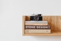Kaboompics - Retro Olympus Trip 35 Camera Display on Stacked Design Books