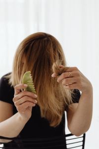Kaboompics - Hands Separating Hair While Combing with a Jade Comb