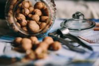 Kaboompics - Glass jar full of walnuts and a nutcracker