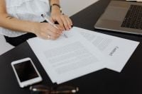 Kaboompics - Signing a Contract Beside Laptop and Smartphone